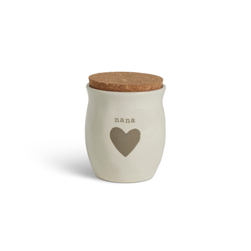 A cream ceramic candle with a gray heart and the word "nana". The candle has a cork lid.