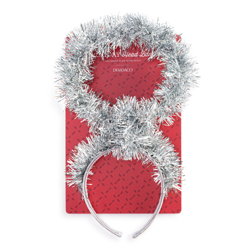 A holiday headband decorated with silver tinsel shaped like a halo and lit with colored lights, displayed on a packaging backer card.