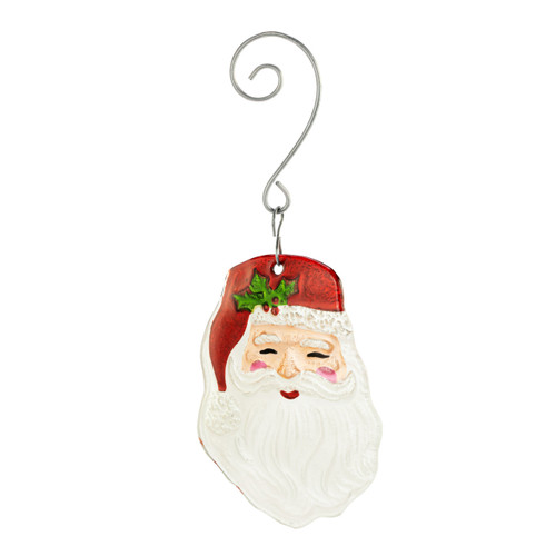 A red and white glass ornament of Santa Claus's smiling face with a curved silver hanger, displayed angled to the left.