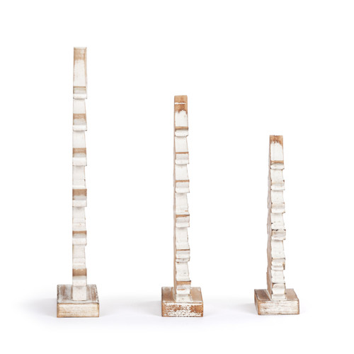 Right profile view of a set of three whitewashed flocked wood carved trees in various sizes.