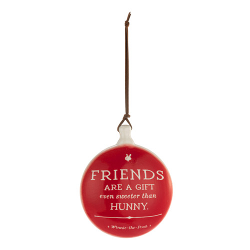A red round disc ornament with the saying "Friends are a gift even sweeter than hunny".