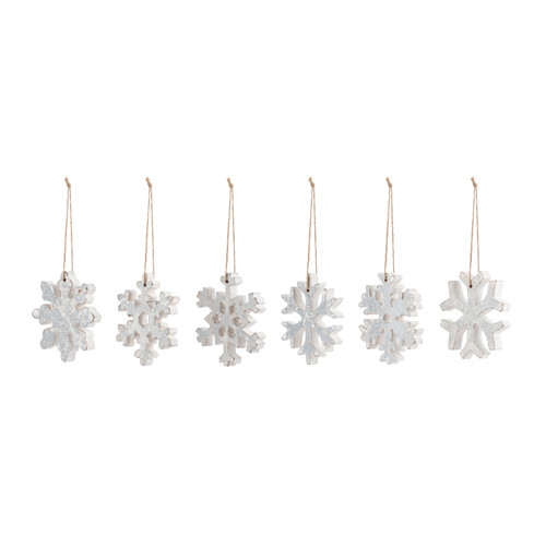 A set of six different snowflake wood ornaments painted silver, displayed angled to the left.