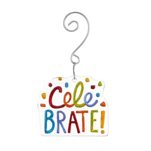 A clear glass ornament that says "Celebrate" in bright colors with confetti and a silver metal hanger.