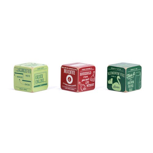 A set of three red and green painted wood dice with instructions on them for a holiday gift exchange game.