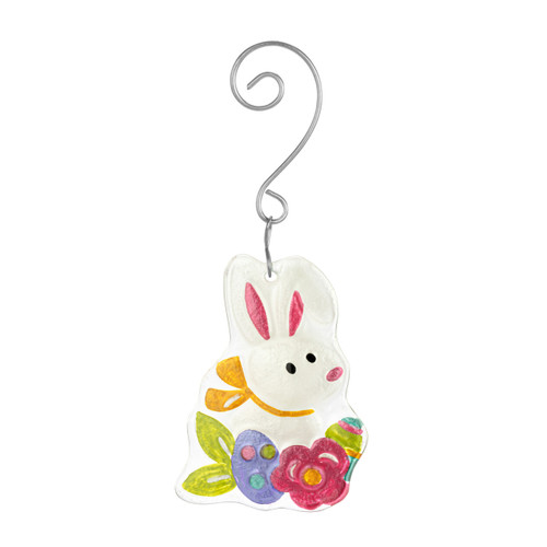 A white Easter bunny glass ornament with colorful flowers and eggs and a curved silver hanger.
