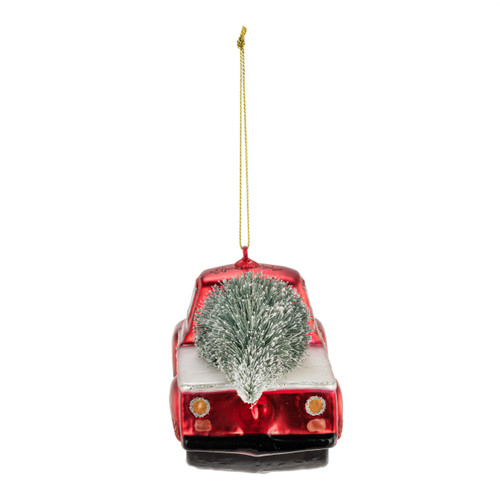Back view of a red truck ornament with a holiday wreath on the front grill and a Christmas tree in the bed.