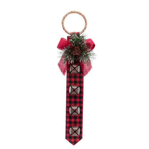 A door knob hanger made of red and black plaid fabric with four jingle bells and an evergreen sprig decoration.