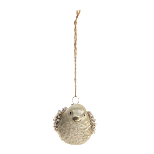 A little gold bird ornament with wings decorated with small white and gold beads.