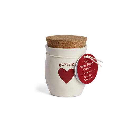 A cream ceramic container that says "giving" with a red heart and a cork lid. There is a poured candle inside, displayed with a product tag attached.