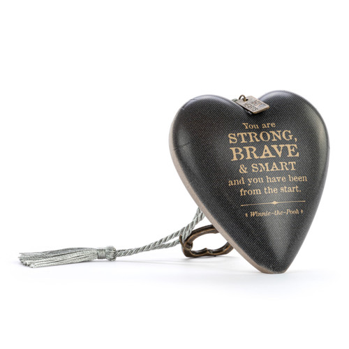 Heart shaped sculpture with a silver tassel and metal key attached. The heart has a dark gray background and says "You are Strong, Brave & Smart and you have been from the start", displayed angled to the right.