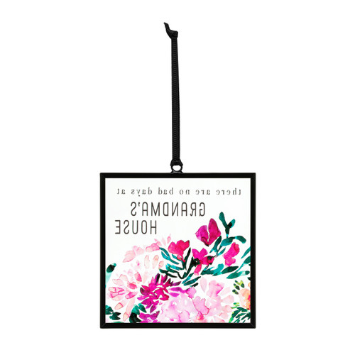 Back view of a small square shaped sun catcher with illustrated pink flowers and the saying "there are no bad days at Grandma's House".