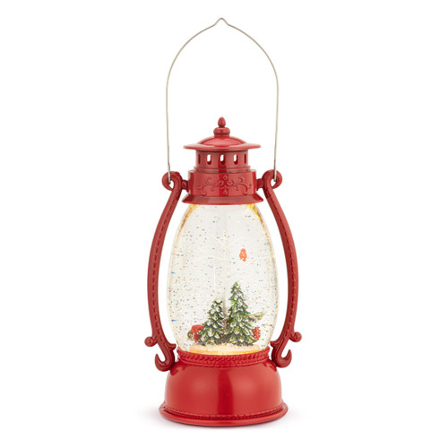 Back view of a lit red lantern with a snowy scene including a red truck, trees and a red cardinal inside.