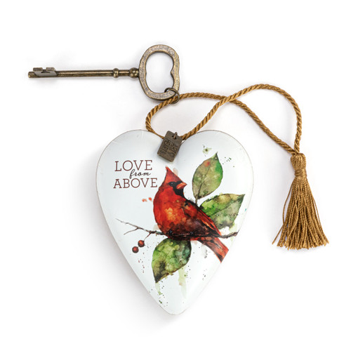 Heart shaped sculpture with a gold tassel and metal key attached. The heart is white with a red cardinal perched on a branch and says "Love from Above".