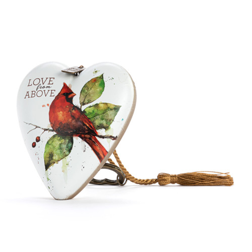 Heart shaped sculpture with a gold tassel and metal key attached. The heart is white with a red cardinal perched on a branch and says "Love from Above", displayed angled to the left.