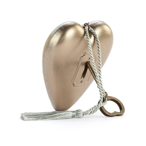 Back view with the heart propped on the key of a heart shaped sculpture with a silver tassel and metal key attached. The heart has the image of Pooh eating honey on a brown background and says "I wouldn't trade you for all the hunny in the world".