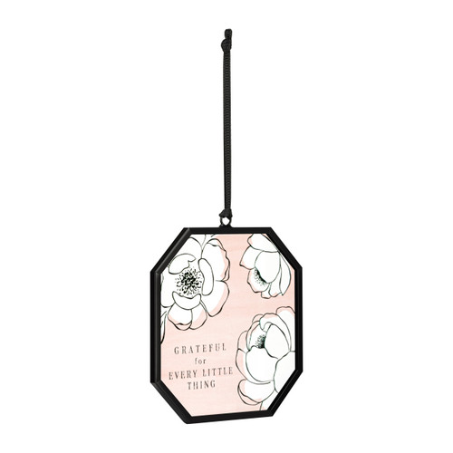 A small octagon shaped sun catcher with illustrated white flowers, a peach background and the saying "Grateful for Every Little Thing", displayed angled to the right.