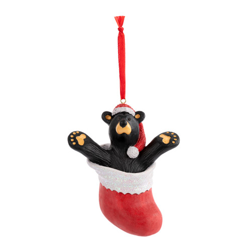 A hanging ornament of a black bear wearing a red Santa hat inside a red stocking.