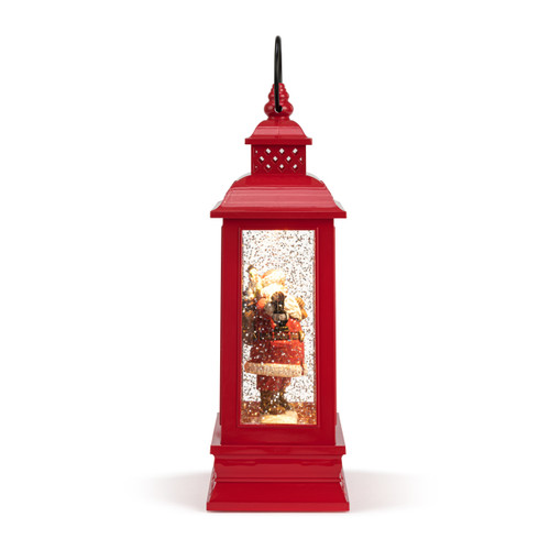 Right profile view of a red lit musical lantern with the image of Santa standing by his sleigh in the snow.