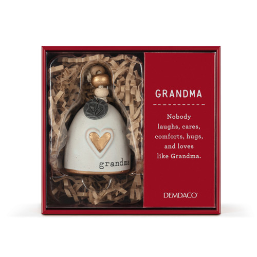 A mini cream bell with a gold heart on the front and the word "grandma". There are beads and a metal token at the top of the bell, displayed in a red packaging box.