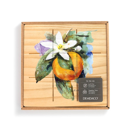 A square wood board for tic tac toe with a watercolor image of an orange blossom, displayed in a packaging box.