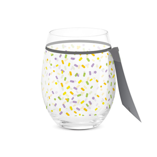 A clear stemless wine glass with a colorful confetti pattern all around the glass, displayed with the product tag attached.