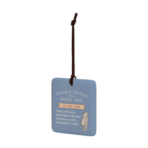 A square blue hanging tile magnet ornament that says "Pooh's Guide for a Good Day on the lake" with an image of Pooh, displayed angled to the left.
