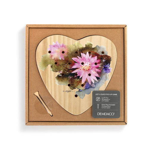 A wood heart shaped peg game with a watercolor image of a bitterroot, displayed in a packaging box.