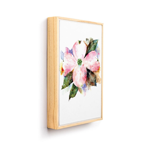 A light wood framed wall art of a watercolor blooming American dogwood, displayed angled to the right.