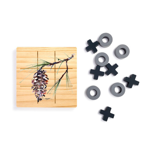 A square wood board for tic tac toe with a watercolor image of a white pine branch, displayed next to a set of X's and O's in gray and black.