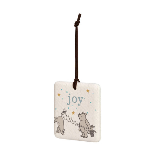 A square cream hanging tile magnet ornament that says "Joy", with an image of Pooh, Piglet and Eeyore at the bottom, displayed angled to the left.