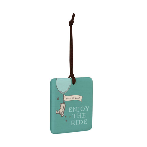 A square green hanging tile magnet ornament that says "Enjoy The Ride" with an image of Pooh hanging on a balloon that says "lake or bust", displayed angled to the right.