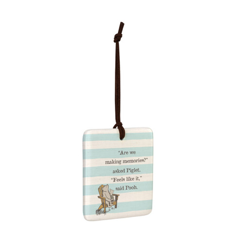 A square light blue and white striped hanging tile magnet ornament that says "Are we making memories?" asked Piglet. "Feels like it," said Pooh, with an image of Pooh and Piglet sitting on a chair, displayed angled to the right.