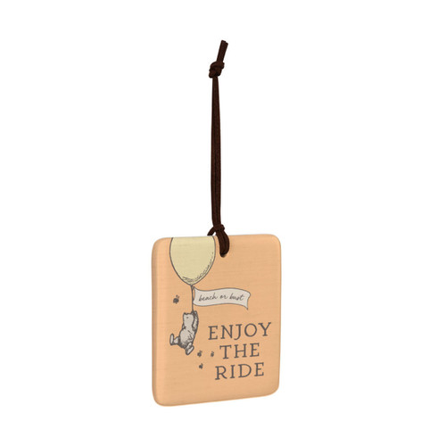 A square orange hanging tile magnet ornament that says "Enjoy The Ride", with an image of Pooh hanging from a balloon that says "beach or bust", displayed angled to the right.