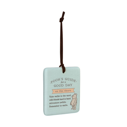 A square light blue hanging tile magnet ornament that says "Pooh's Guide for a Good Day on the shore", with an image of Pooh at the bottom, displayed angled to the right.