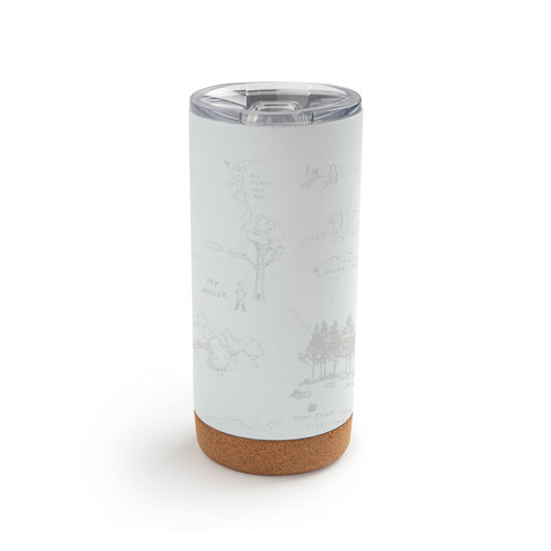 Back view of a white cork bottom tumbler with a clear plastic lid. The tumbler has Pooh's Guide for a Good day at the beach with the hundred acre wood lightly in the background.