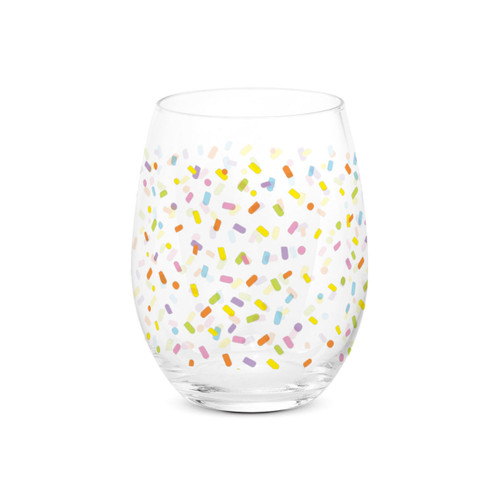 A clear stemless wine glass with a bright colorful confetti pattern all around the glass.