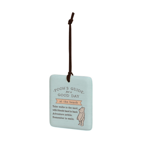 A square light blue hanging tile magnet ornament that says "Pooh's Guide for a Good Day at the beach", with an image of Pooh at the bottom, displayed angled to the left.