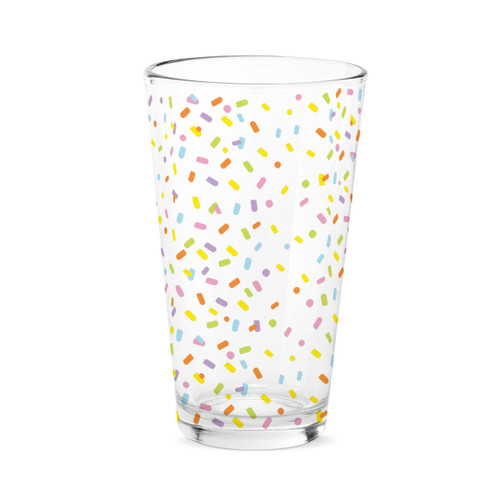 A clear pint glass with a bright colored confetti pattern.