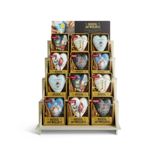 A four tier light wood displayer with an assortment of holiday musical art hearts in packaging boxes.
