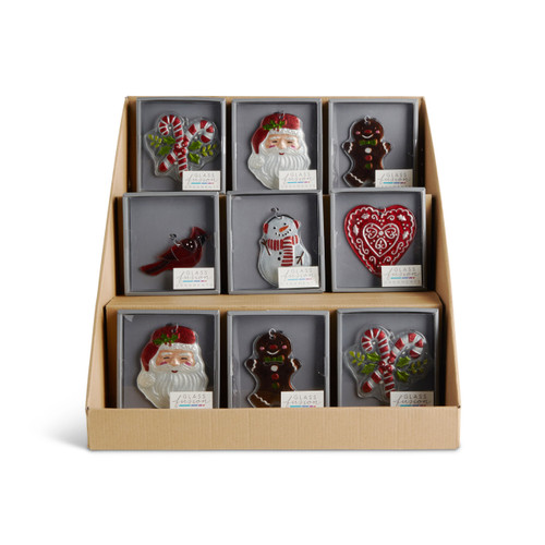 A three tier cardboard displayer box with an assortment of Christmas themed glass ornaments in packaging boxes.
