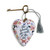 A white floral heart shaped sculpture that says "She believed she could, so she did" with a silver tassel and metal key attached.