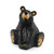 figure of carved black bear sitting looking up