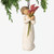 Front view, female figure in cream dress, holding tall bouquet of fuchsia calla lilies. Hook and loop affixed to head