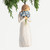Front view, female figure in cream dress, holding bouquet of blue forget-me-not flowers to face. Hook and loop affixed to head