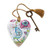A white floral heart shaped sculpture with a blue bird and says "kind in heart" with a gold tassel and metal key attached.