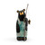 A large black bear figurine wearing light blue overalls and holding a wood fishing pole with a small fish on the hook.