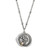 A close up image of a circular pendant with a gold heart and a silver tree on a dainty silver necklace.