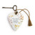 A white floral Art Heart that says "when friends are near, happiness is here." The heart has a gold tassel and a bronze key.