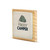 A square wood plaque with a cream tile attached that has a green tent and says "Happy Camper" angled to the left.