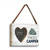 A light wood rectangular hanging wood frame with a 2 inch heart shaped opening for a photo next to the image of a green tent and the saying "Happy Camper" shown angled to the right.